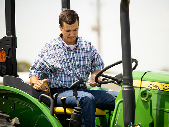 Boy driving a tractor in a tractor challenge